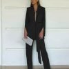 woman-wearing-pleated-lace-up-side-slit-blazer-and-pants