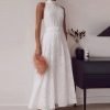 woman-wearing-sleeveless-hollow-out-white-belt-long-dress